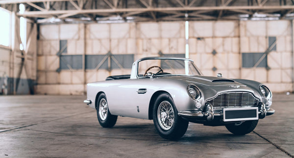 A junior Aston Martin by the Little Car Company in a warehouse