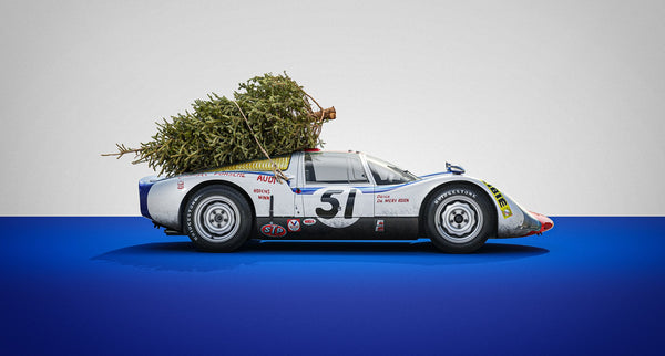 A image of a Porsche Race car with Christmas Tree on its roof