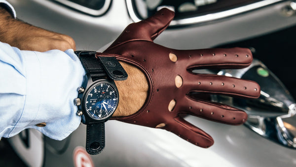 A gentle man putting on a pair of gloves by Cafe Leather and wearing a watch