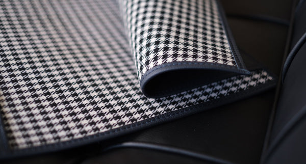 A tool roll by Placek Classic featuring houndstooth material and leather