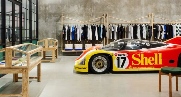 An interior view of the Period Correct shop with a Porsche 962 race car on display